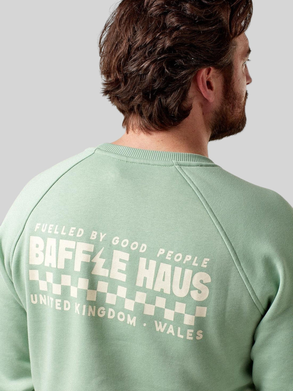 Baffle Haus Flags sweatshirt in granite green with white back graphic print on a man