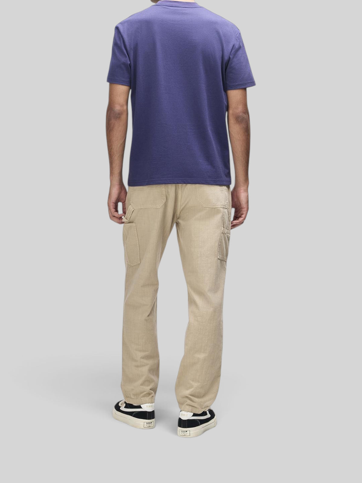 Baffle Haus French Blue box fit short sleeve cotton blend t-shirt worn with beige utility trousers from behind