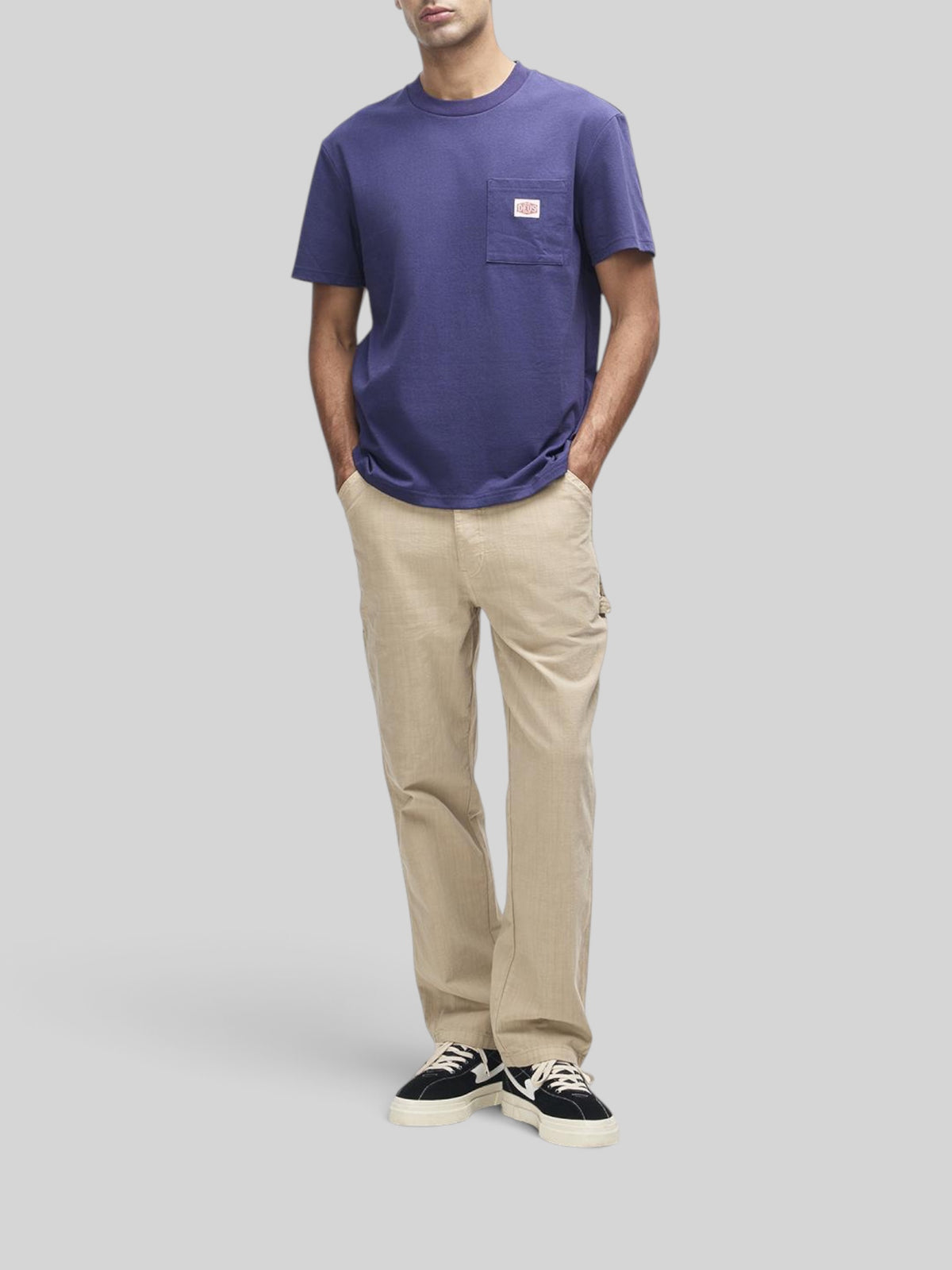 Baffle Haus French blue box fit short sleeve t-shirt with a chest pocket and brand label, worn by a male model.