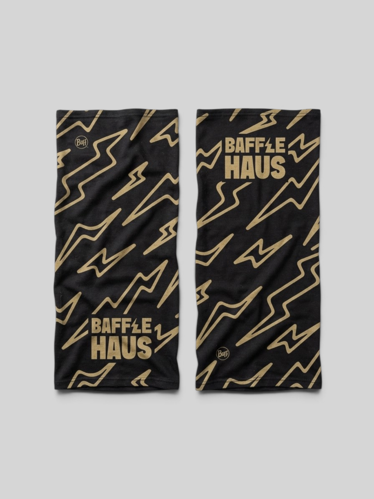 Baffle Haus x BUFF neck tube in black with a gold lightning bolt pattern and Baffle Haus branding.