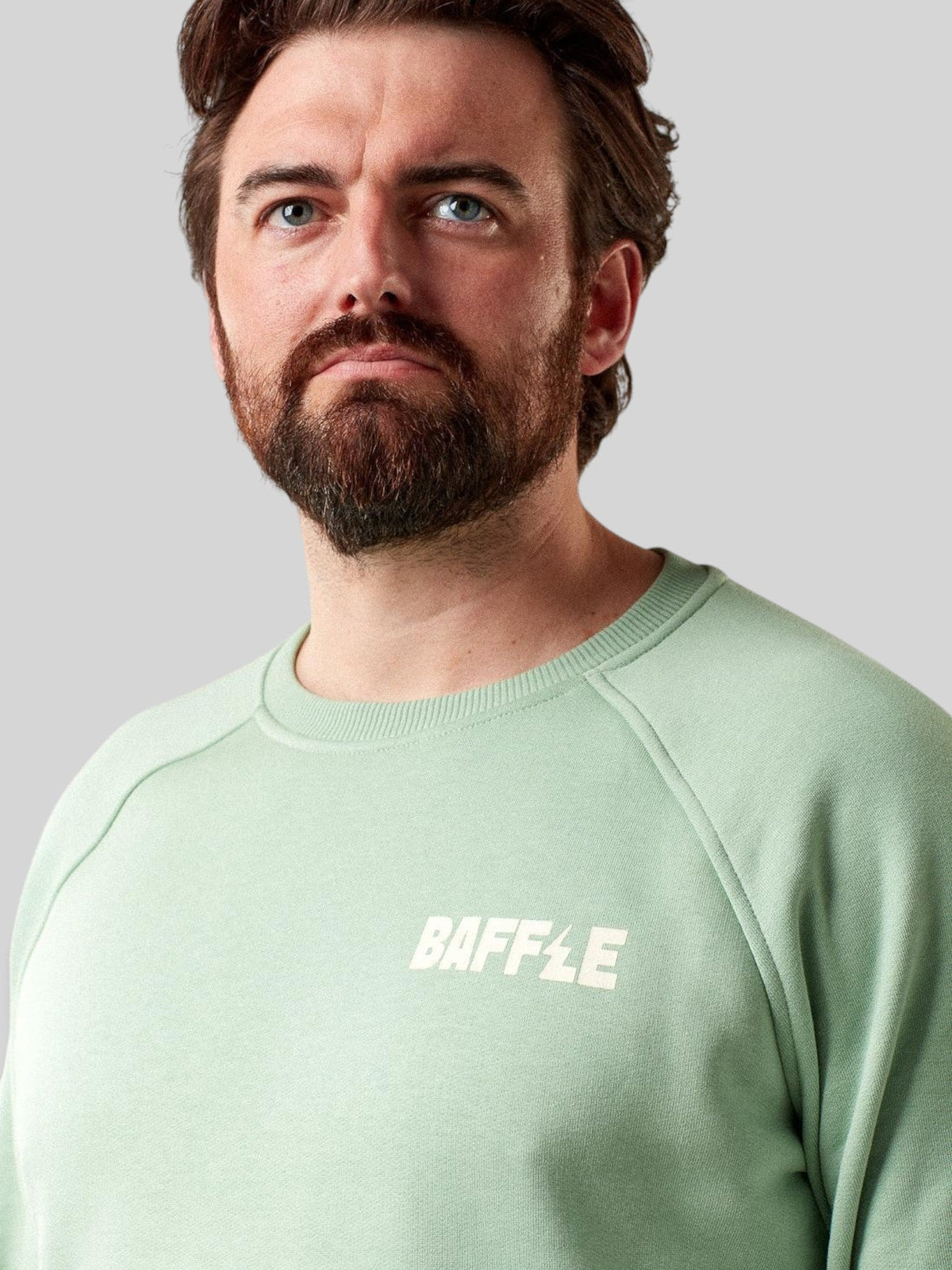 Baffle Haus Flags sweatshirt in granite green with a crew neck and white logo detail on a male model