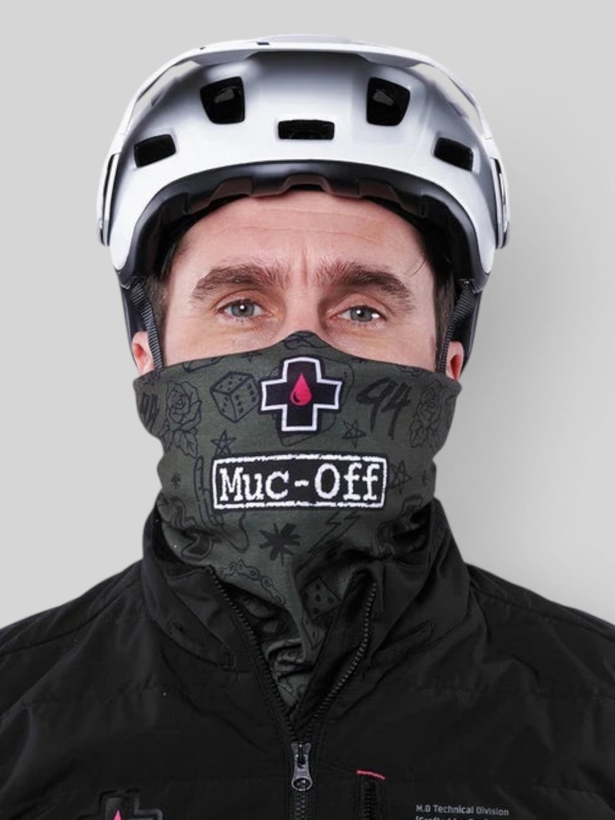 Baffle Haus green punk lightweight neck gaiter worn by a cyclist wearing a white helmet and black jacket