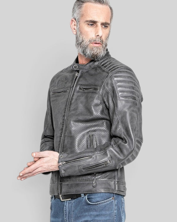 Baffle Haus grey perforated leather motorcycle jacket with padded shoulders and zippered cuffs worn by a bearded man