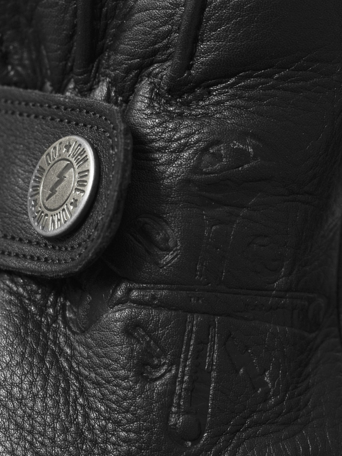 Baffle Haus Grinder black cowhide leather motorcycle glove featuring a branded metal push-button wrist closure.