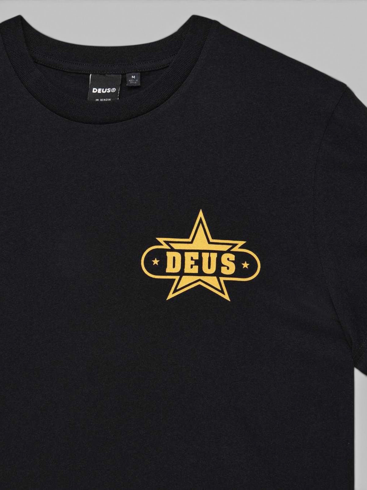 Baffle Haus black organic cotton Gumshoe t-shirt featuring a yellow star-shaped graphic on the chest