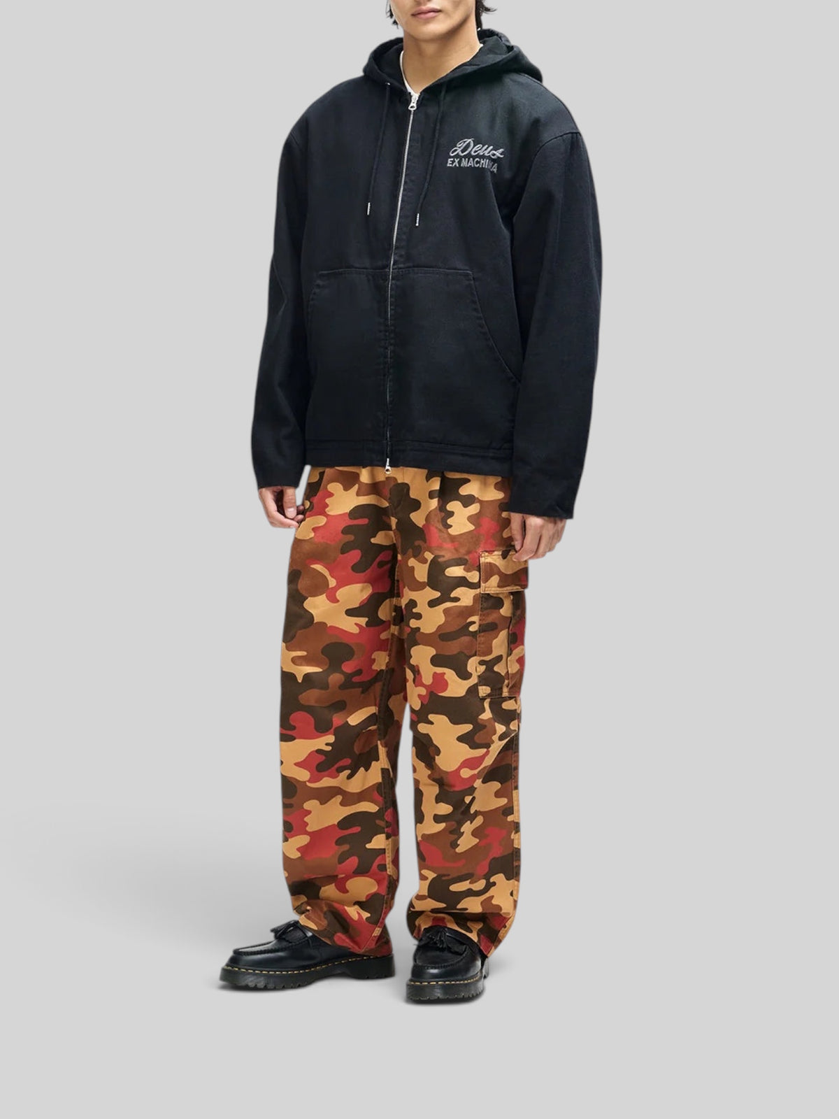 Baffle Haus Harajuku hooded black cotton canvas work jacket with zip front and chest embroidery on a male model