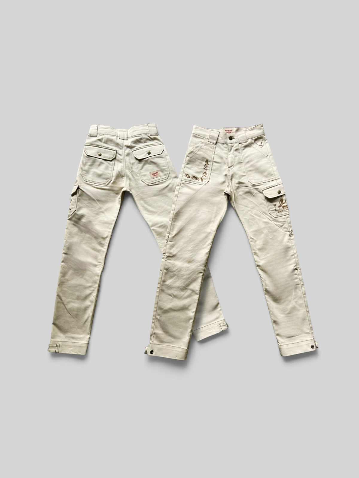 Baffle Haus ivory cargo motorcycle trousers with patch pockets, contrast stitching, and subtle embroidery details.