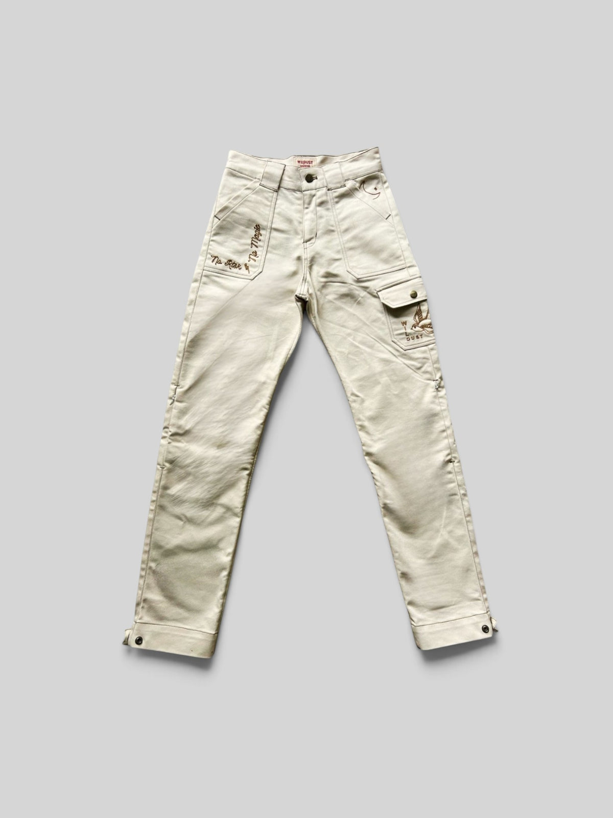 Baffle Haus ivory cargo motorcycle trousers with high waist, patch pockets, and decorative embroidery details.