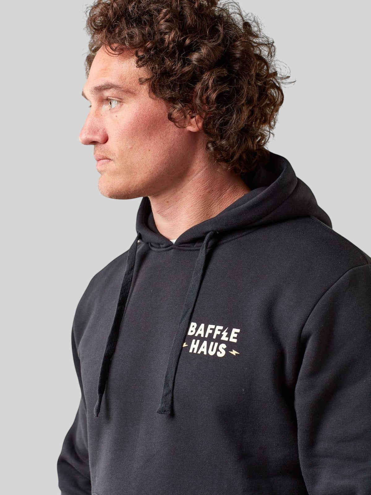 Baffle Haus jet black heavyweight cotton-blend hoodie with white Coffee & Motors chest logo on a male model