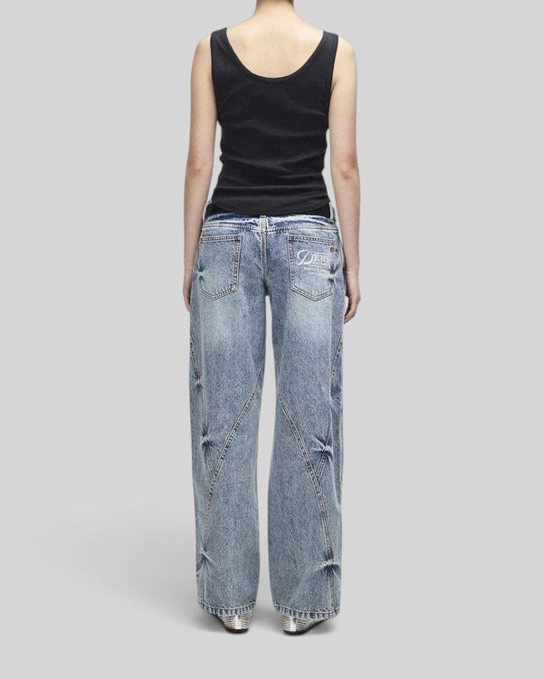Baffle Haus June Shield black slim fit tank top with thin straps and curved hem worn with wide-leg denim jeans
