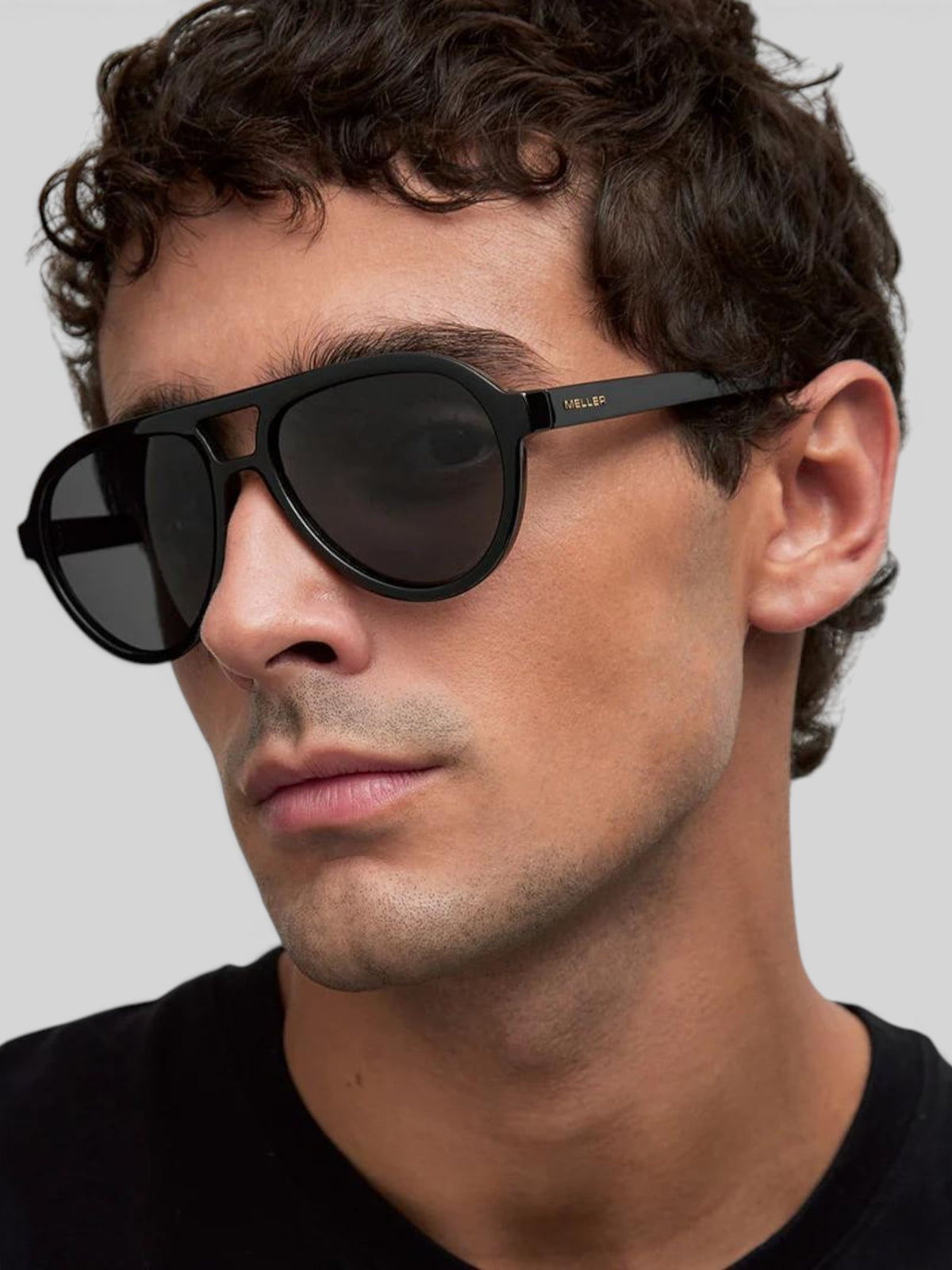 Baffle Haus KENA black aviator sunglasses with polarized lenses and a double bridge worn by a man