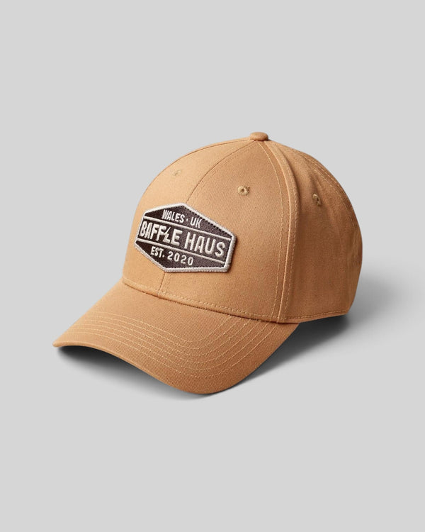 Baffle Haus khaki baseball cap with a structured crown, curved brim, and a branded embroidered patch on the front.