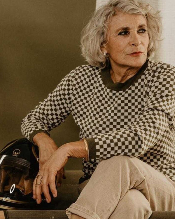 Baffle Haus vintage khaki knitted jumper with a checkerboard pattern, ribbed collar, and cuffs worn by a woman.