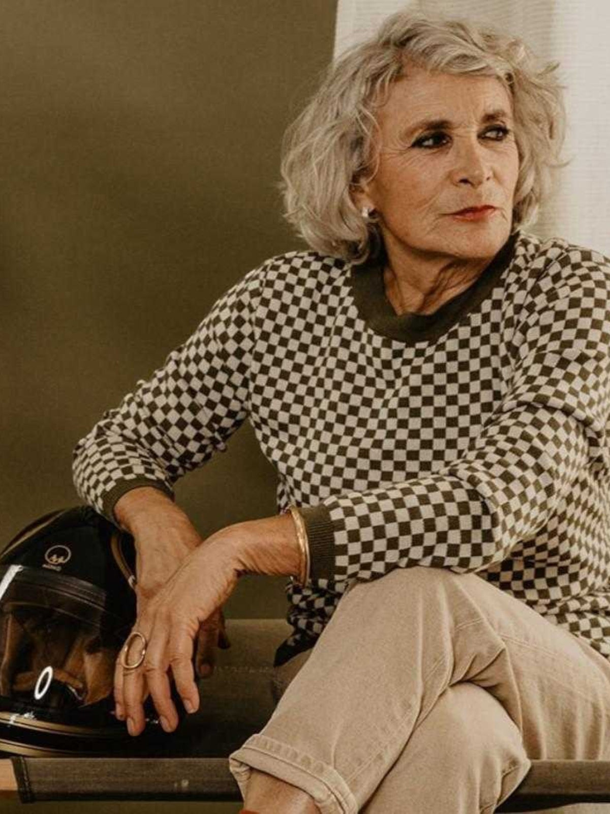 Baffle Haus vintage khaki knitted jumper with a checkerboard pattern, ribbed collar, and cuffs worn by a woman.