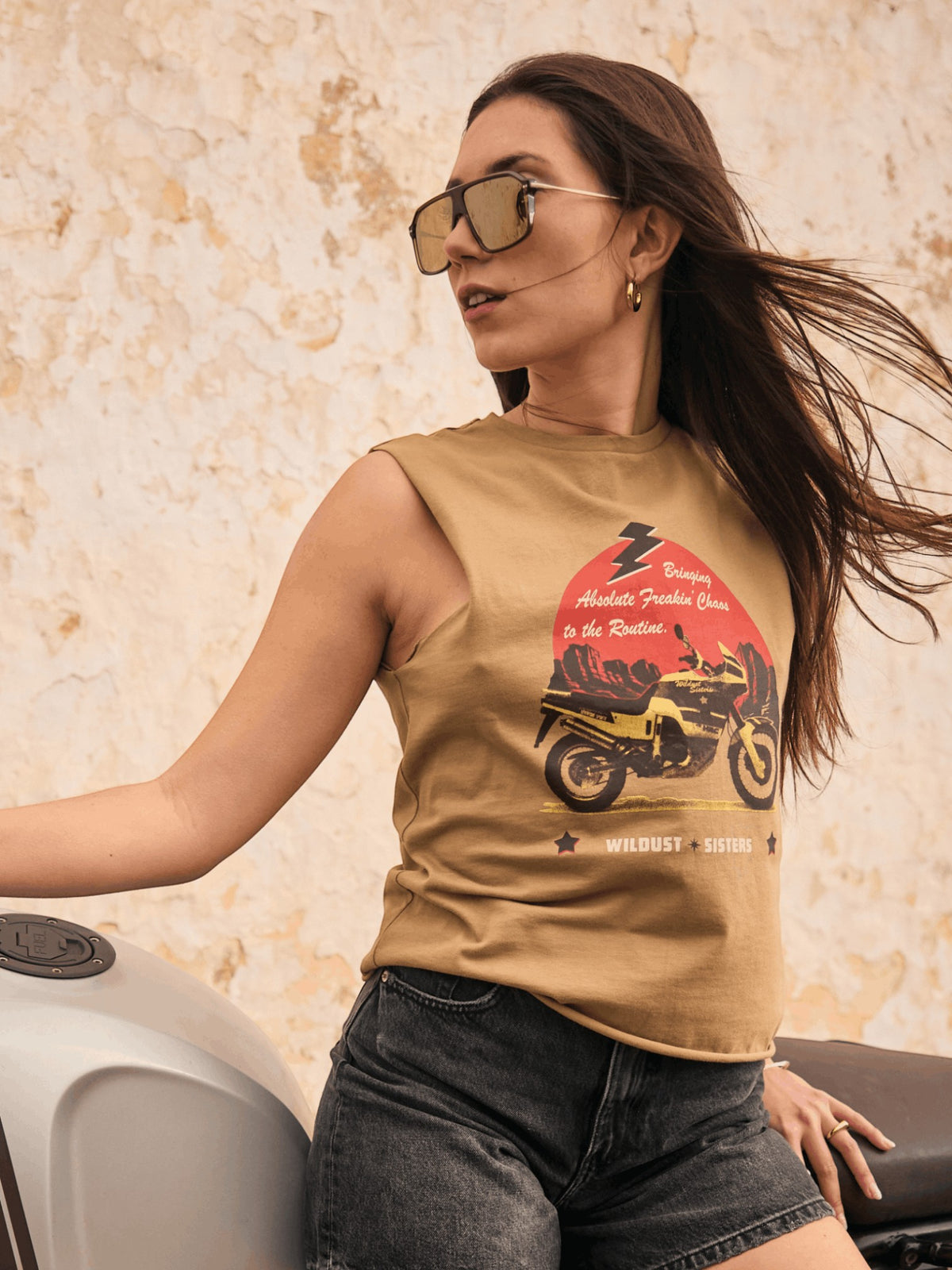 Baffle Haus khaki cotton tank top with motorcycle desert graphic worn by a woman on a motorcycle