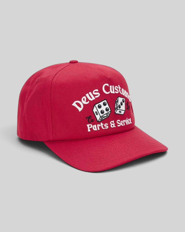 Baffle Haus Knucklebones cap in melon red cotton twill with vintage-inspired embroidered dice graphic and snap back.