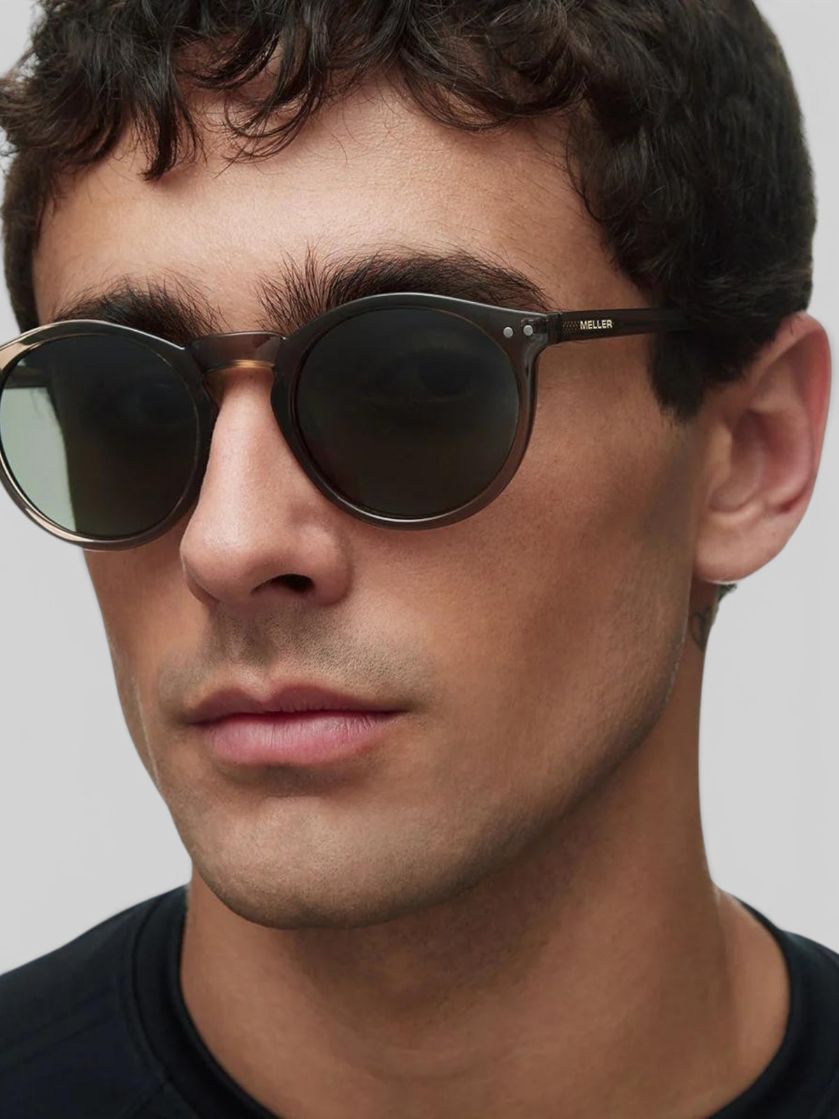 Baffle Haus KUBU sunglasses with rounded camel frames and olive polarized lenses worn by a man