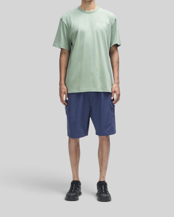 Baffle Haus loden frost green short sleeve cotton t-shirt with chest graphic print worn by a model