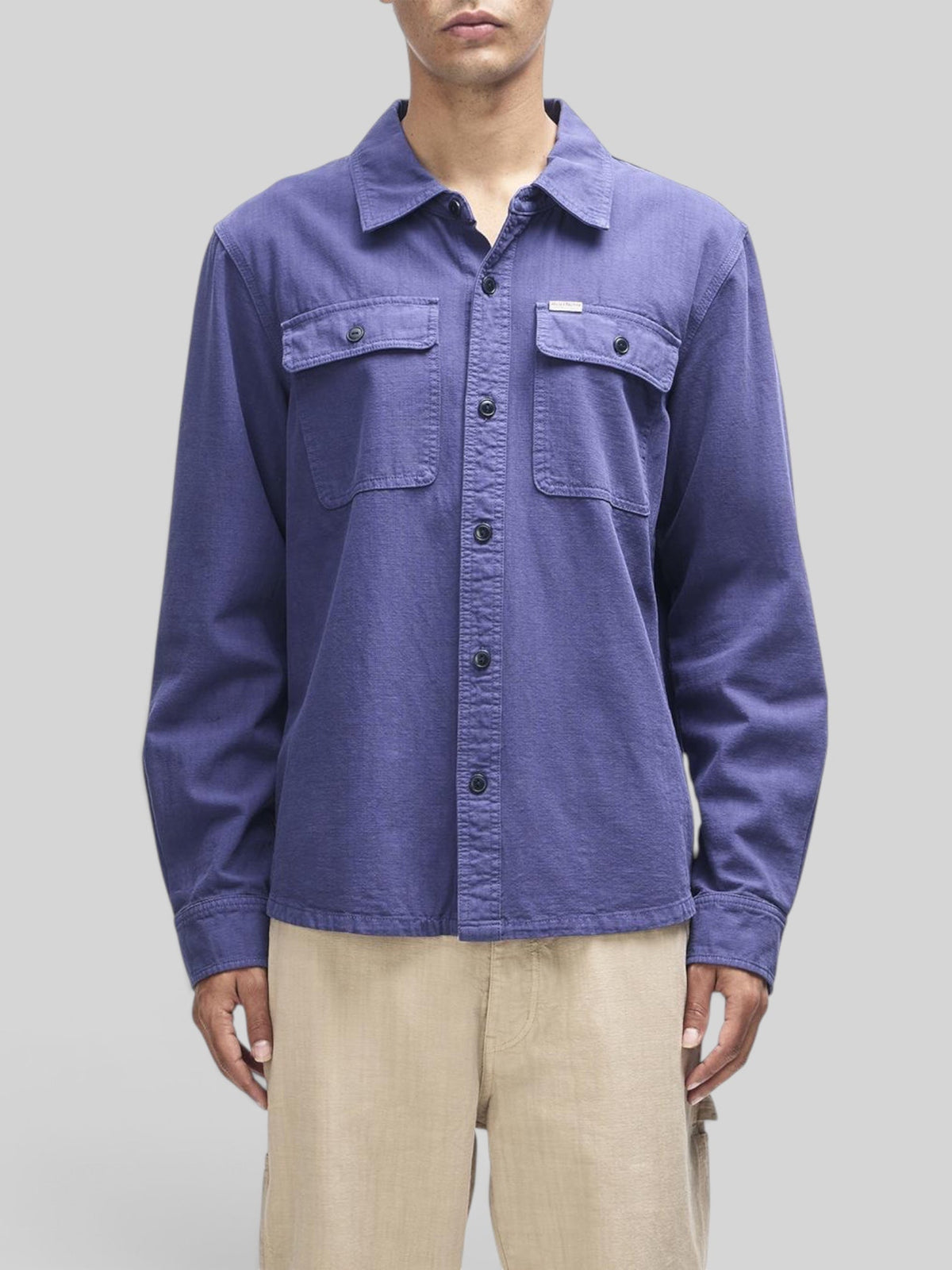 Baffle Haus Vacay Chambray Shirt in mechanic blue with chest flap pockets and button closure on a model