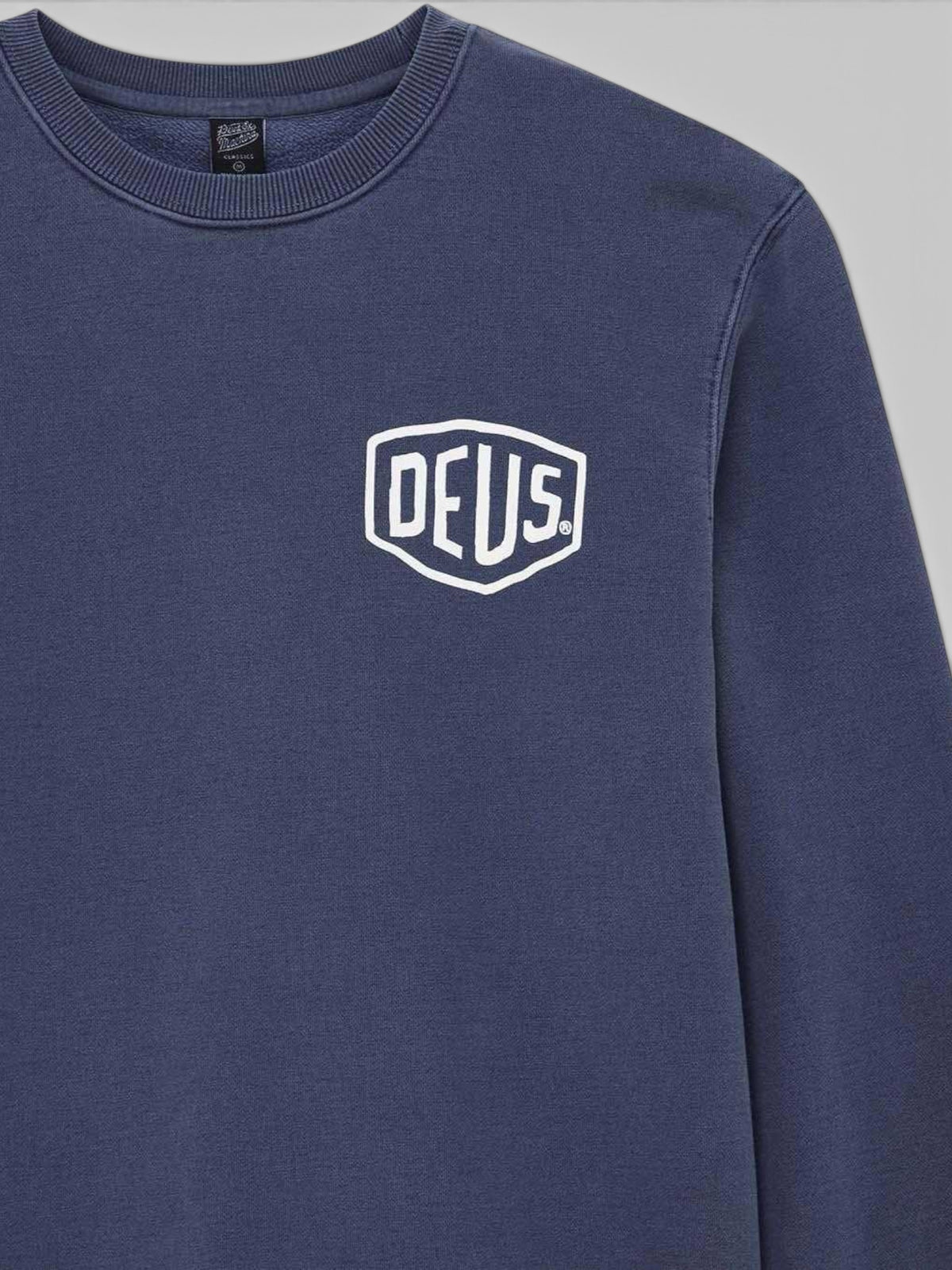 Baffle Haus Deus Shield crew neck sweatshirt in mechanic blue heavyweight loop back fleece with white chest graphic