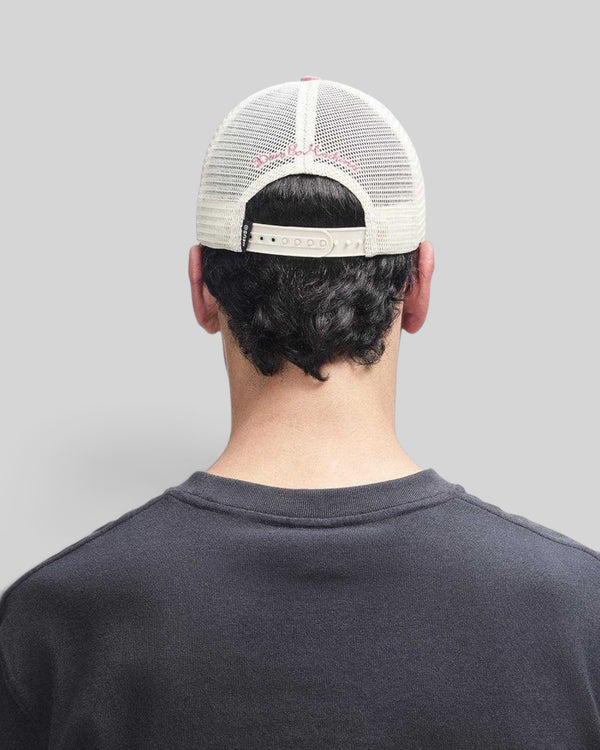 Rear view of a Baffle Haus melon red trucker hat with a white mesh back and adjustable plastic snap closure