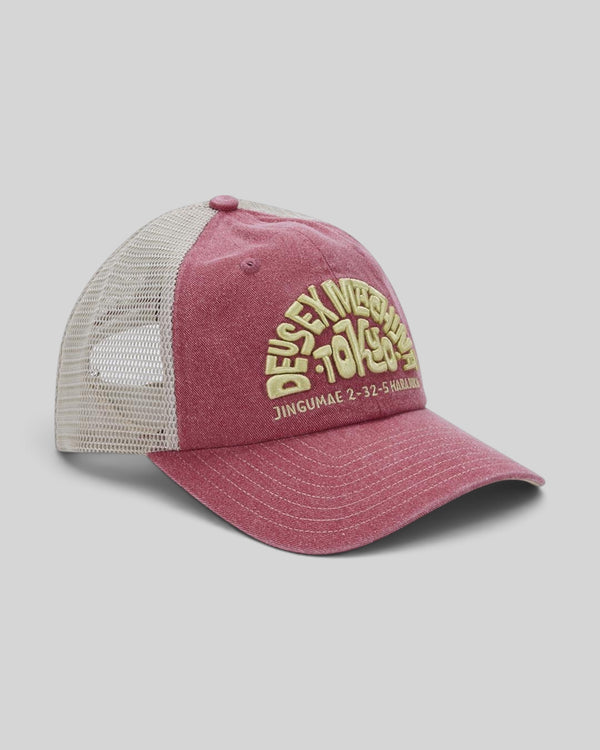 Baffle Haus Tokyo Address trucker hat in melon red with cream mesh back, contrast stitching, and front embroidery.