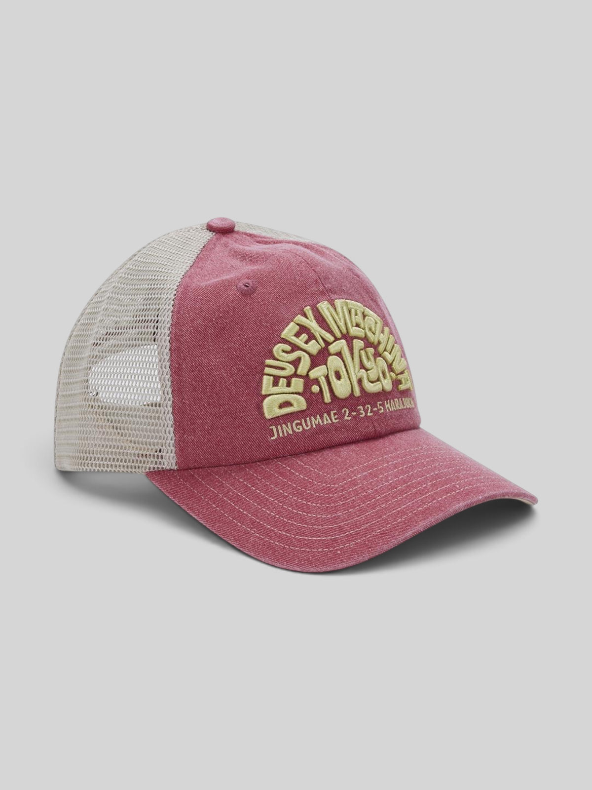 Baffle Haus Tokyo Address trucker hat in melon red with cream mesh back, contrast stitching, and front embroidery.
