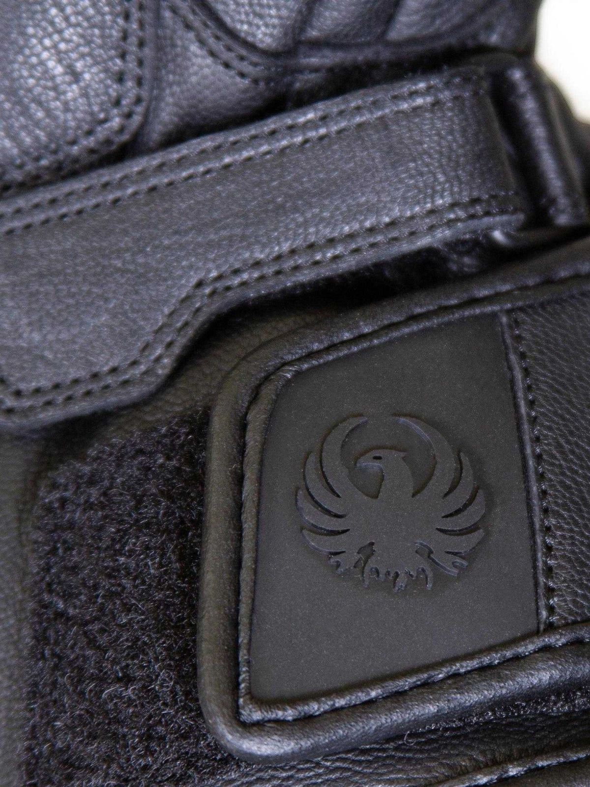Baffle Haus Merlin Calton black leather motorcycle glove featuring adjustable Velcro wrist strap and embossed logo