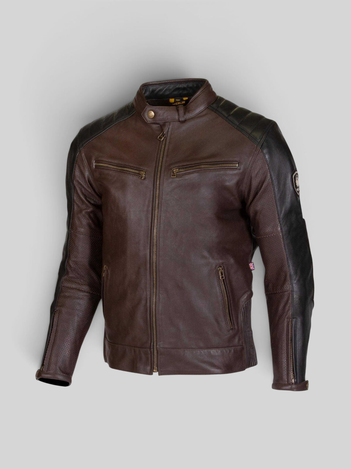Baffle Haus Merlin Chase D30 leather motorcycle jacket in brown and black with perforated panels and brass zippers.
