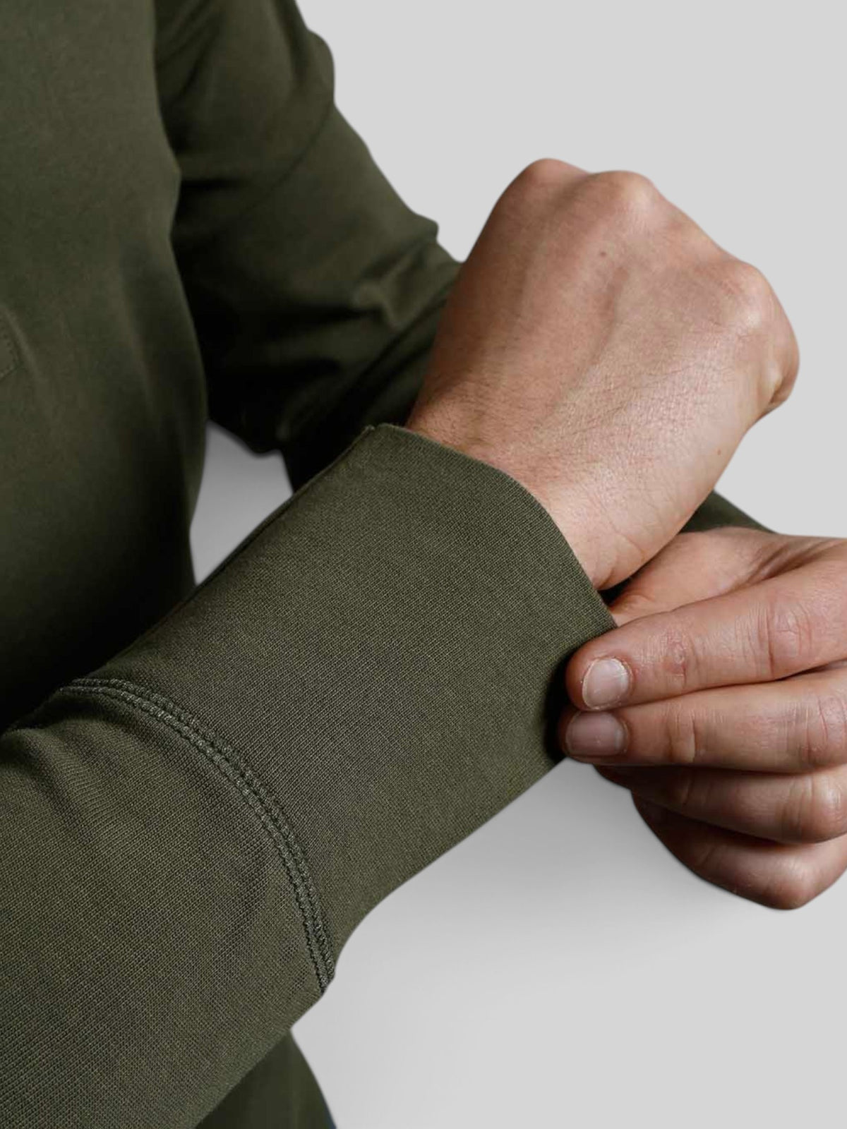 Close-up of Baffle Haus 1927 Henley long sleeve shirt in Mojave Green cotton with ribbed cuff detail