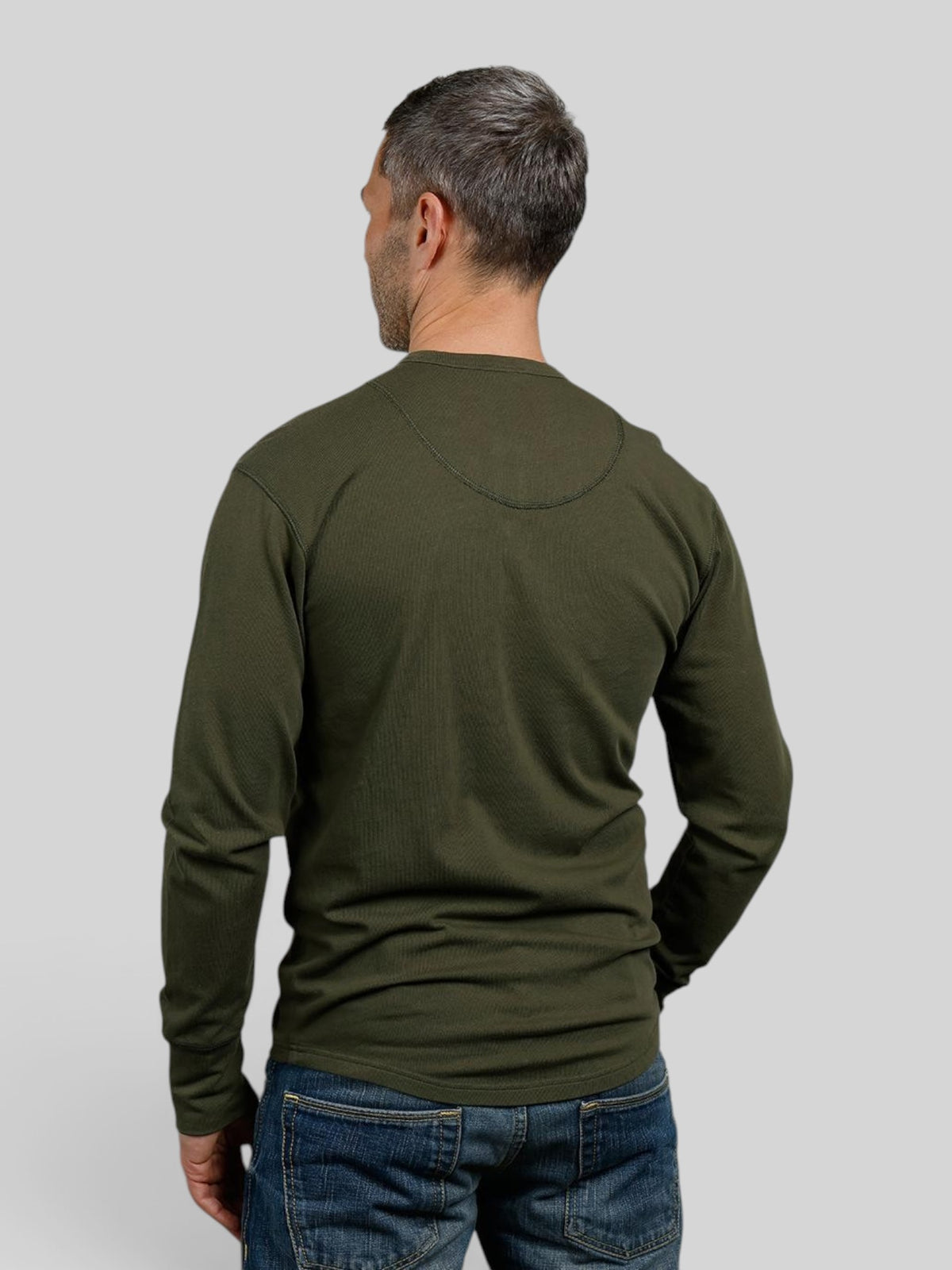 Baffle Haus 1927 Henley long sleeve shirt in Mojave green cotton with a rounded hem, back view on a male model