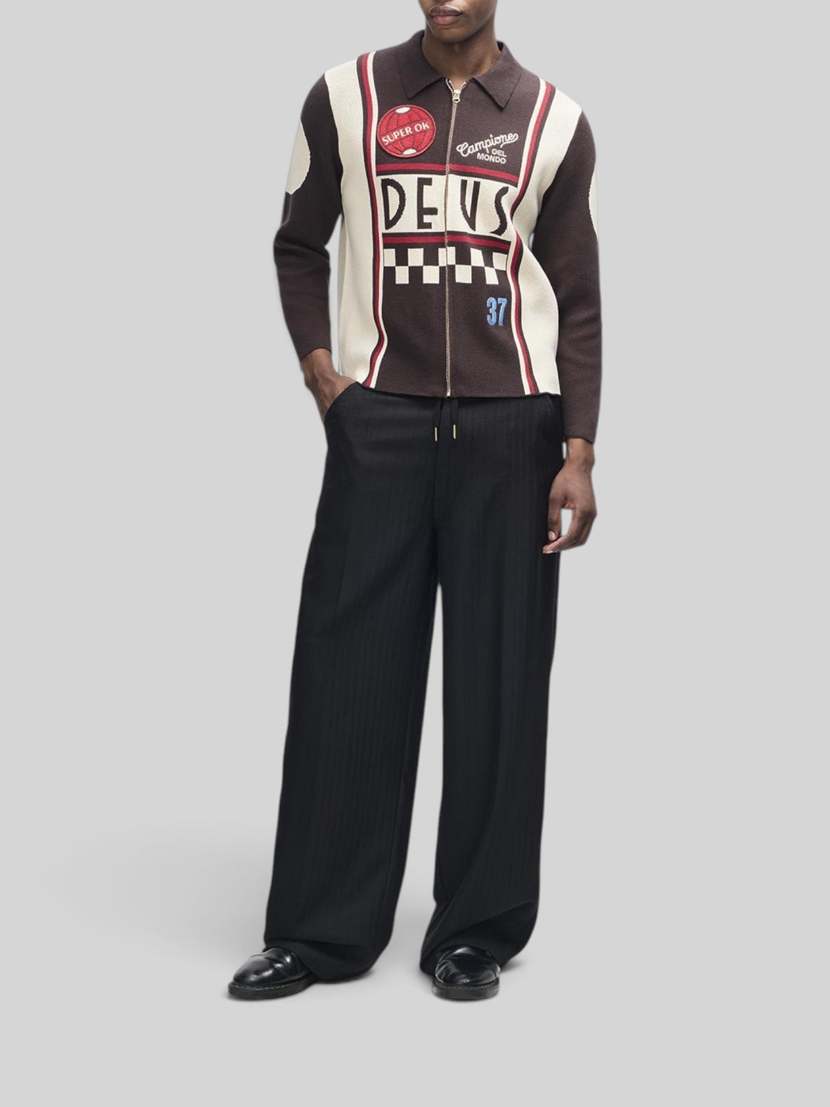Baffle Haus Monte Carlo knit cardigan in java brown with graphic jacquard moto details, zip front, and patches.