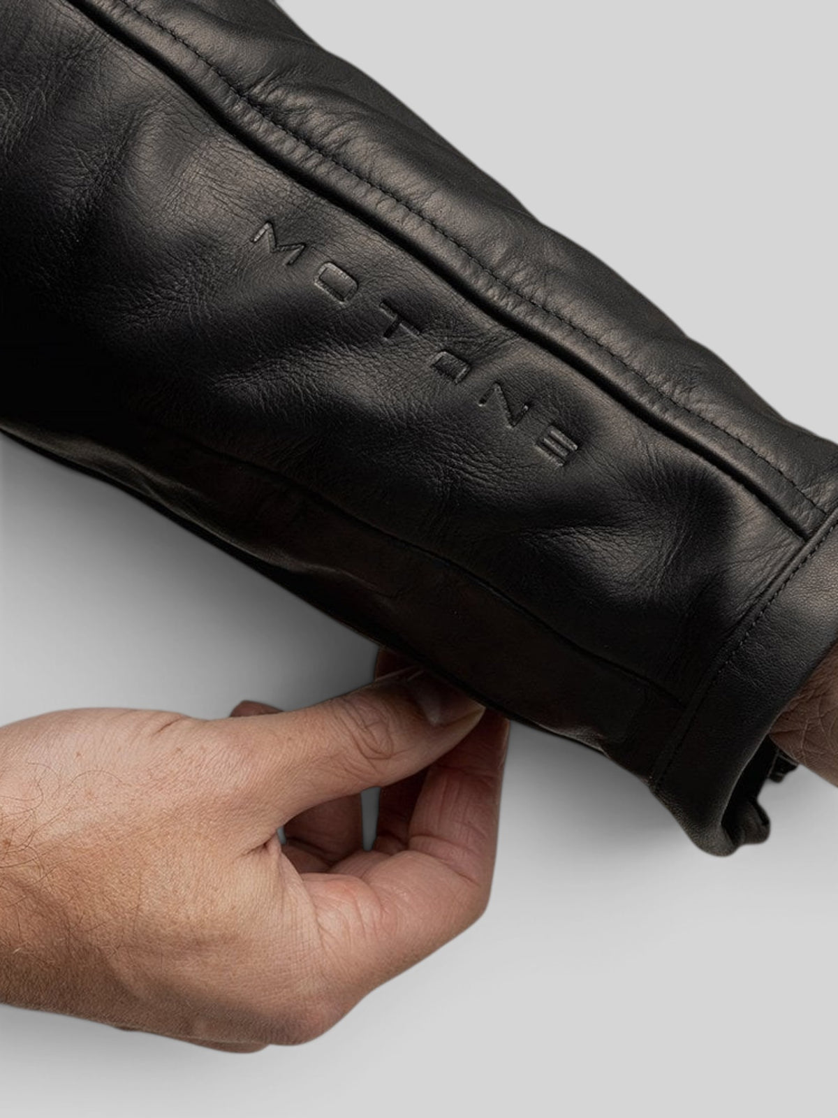 Baffle Haus Motone Revolver black cowhide leather motorcycle jacket sleeve with embossed branding detail