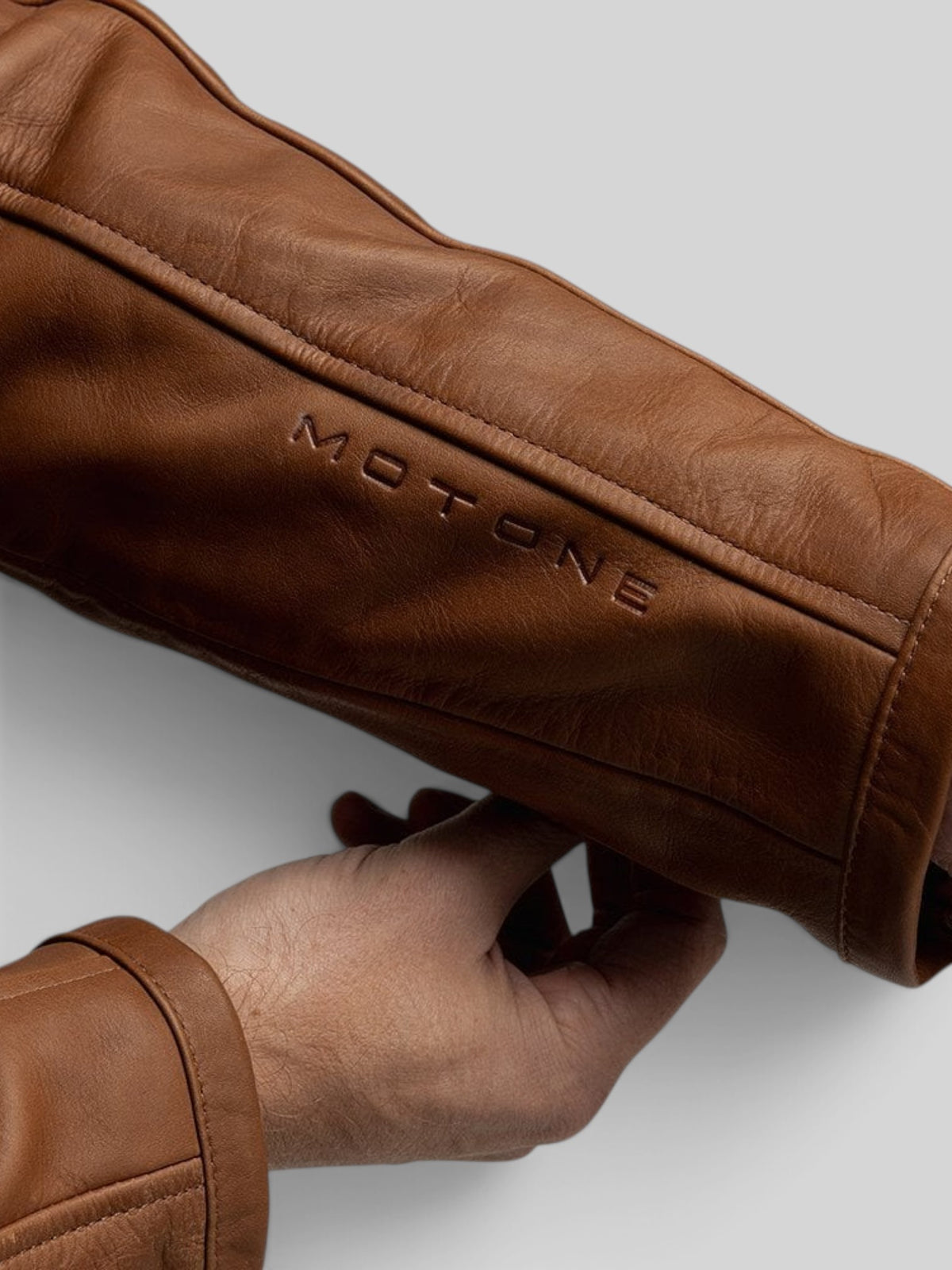 Baffle Haus Motone Revolver tobacco leather motorcycle jacket sleeve with embossed branding and premium cowhide