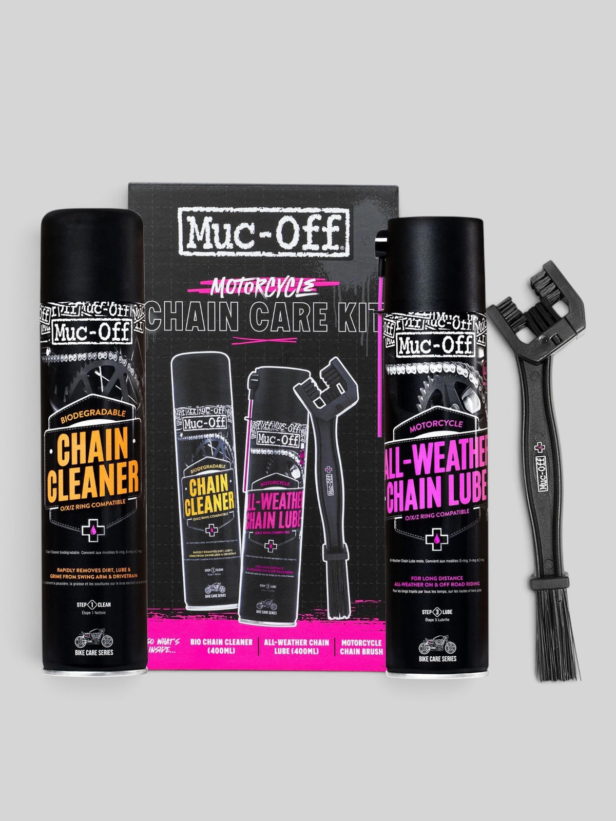 Baffle Haus motorcycle chain care kit featuring chain cleaner, all-weather lube, and a cleaning brush on grey background