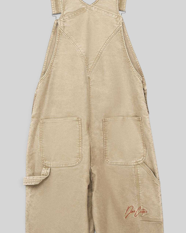 Baffle Haus Mouton overalls in safari beige organic cotton moleskin with front patch pockets and embroidery detail.