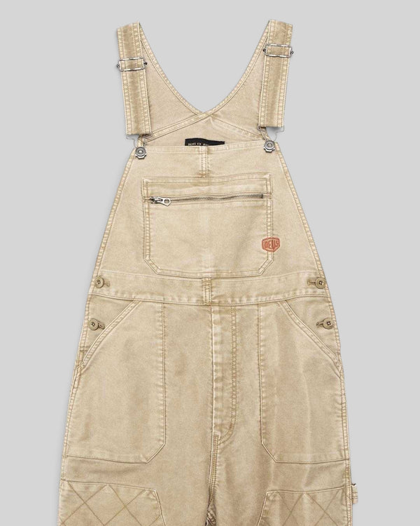 Baffle Haus Mouton overalls in safari beige organic cotton moleskin with front patch pockets and quilted knee detail.