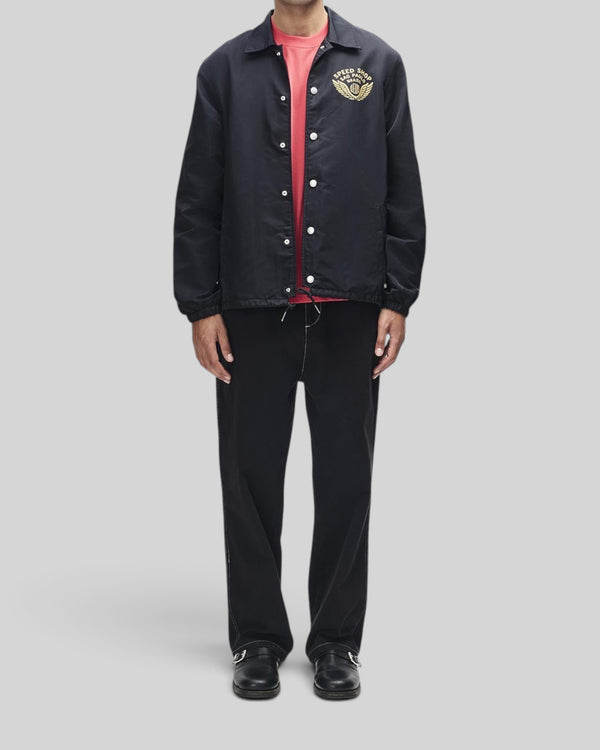 Baffle Haus Munificence black recycled nylon coach jacket with chest graphic and snap button closure