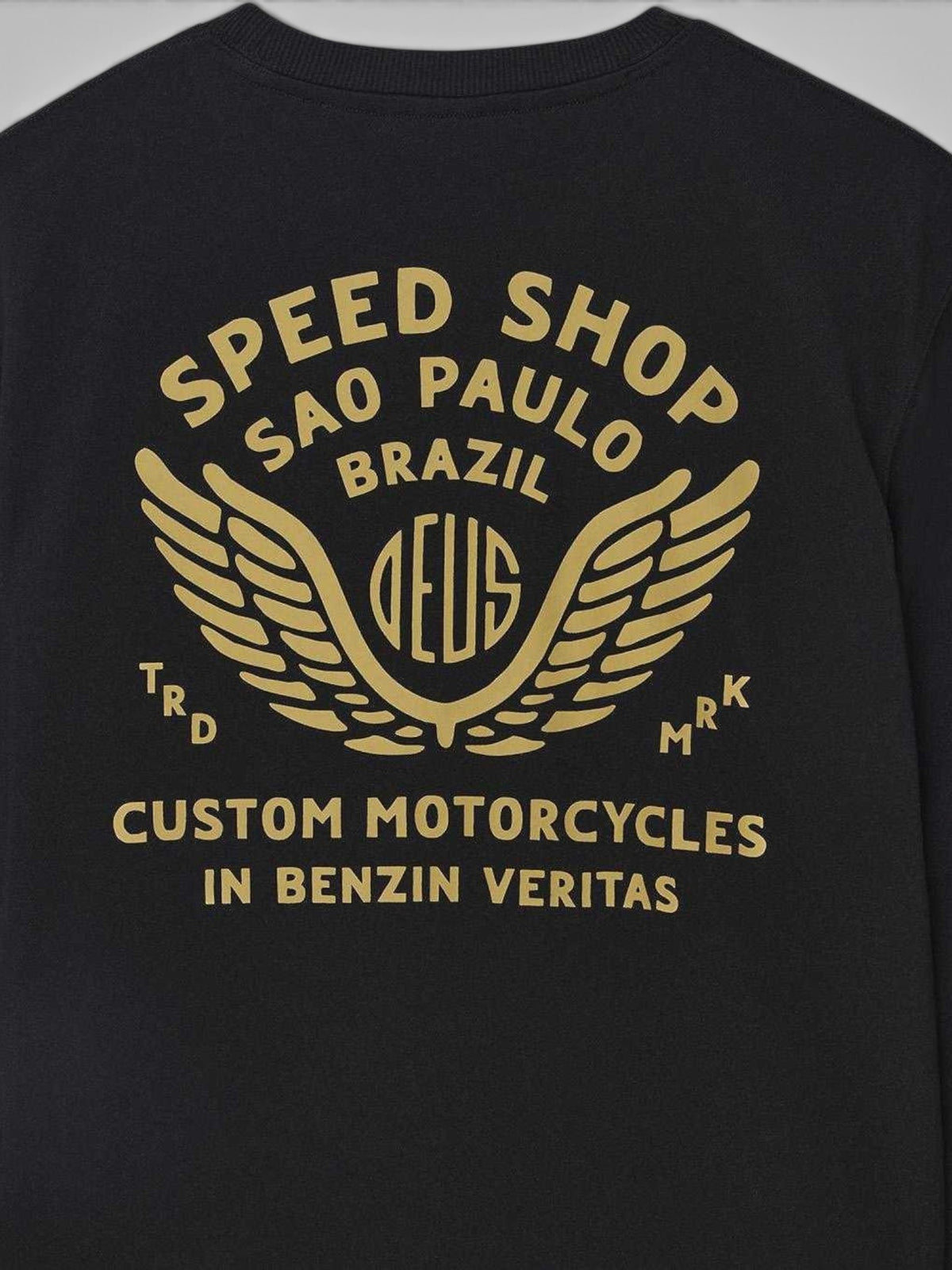 Baffle Haus Munificence crew fleece in black with gold graphic print on the back featuring Deus Speed Shop branding.