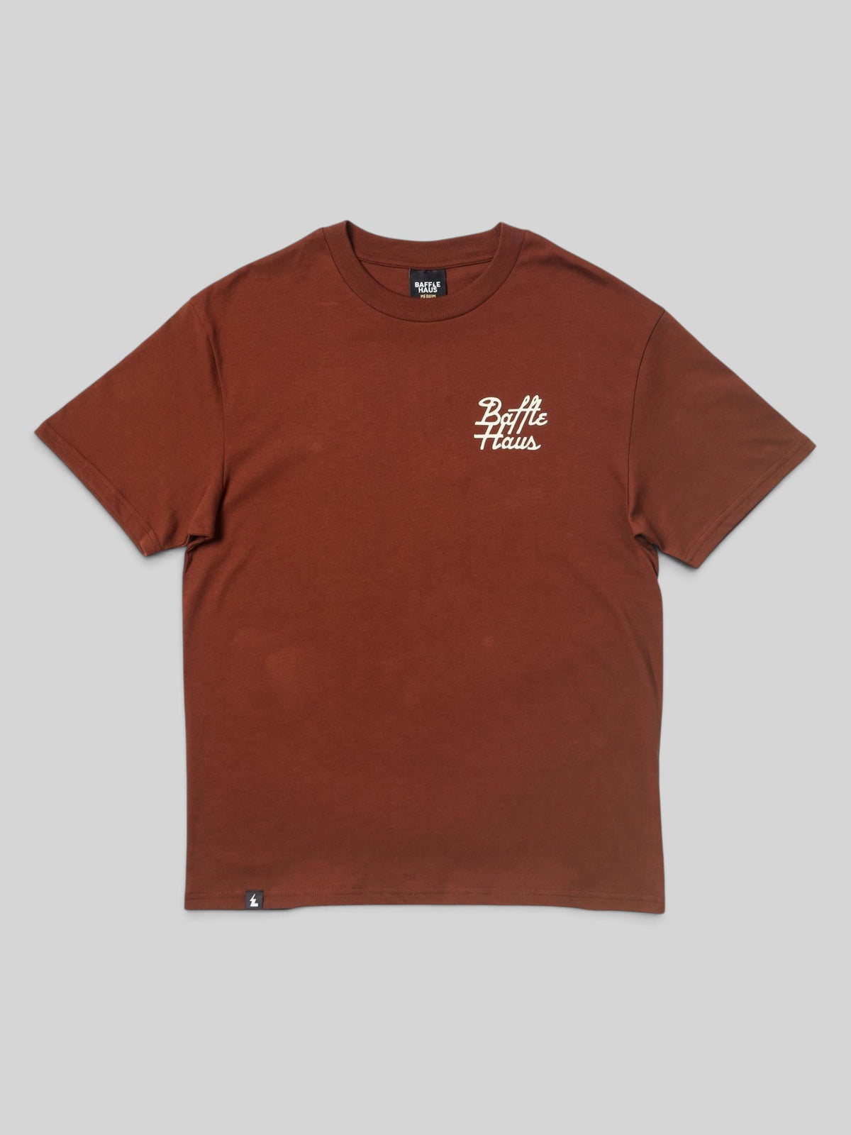 Baffle Haus Mustang Tee in cocoa brown cotton with white script logo on the chest and small hem tag detail.