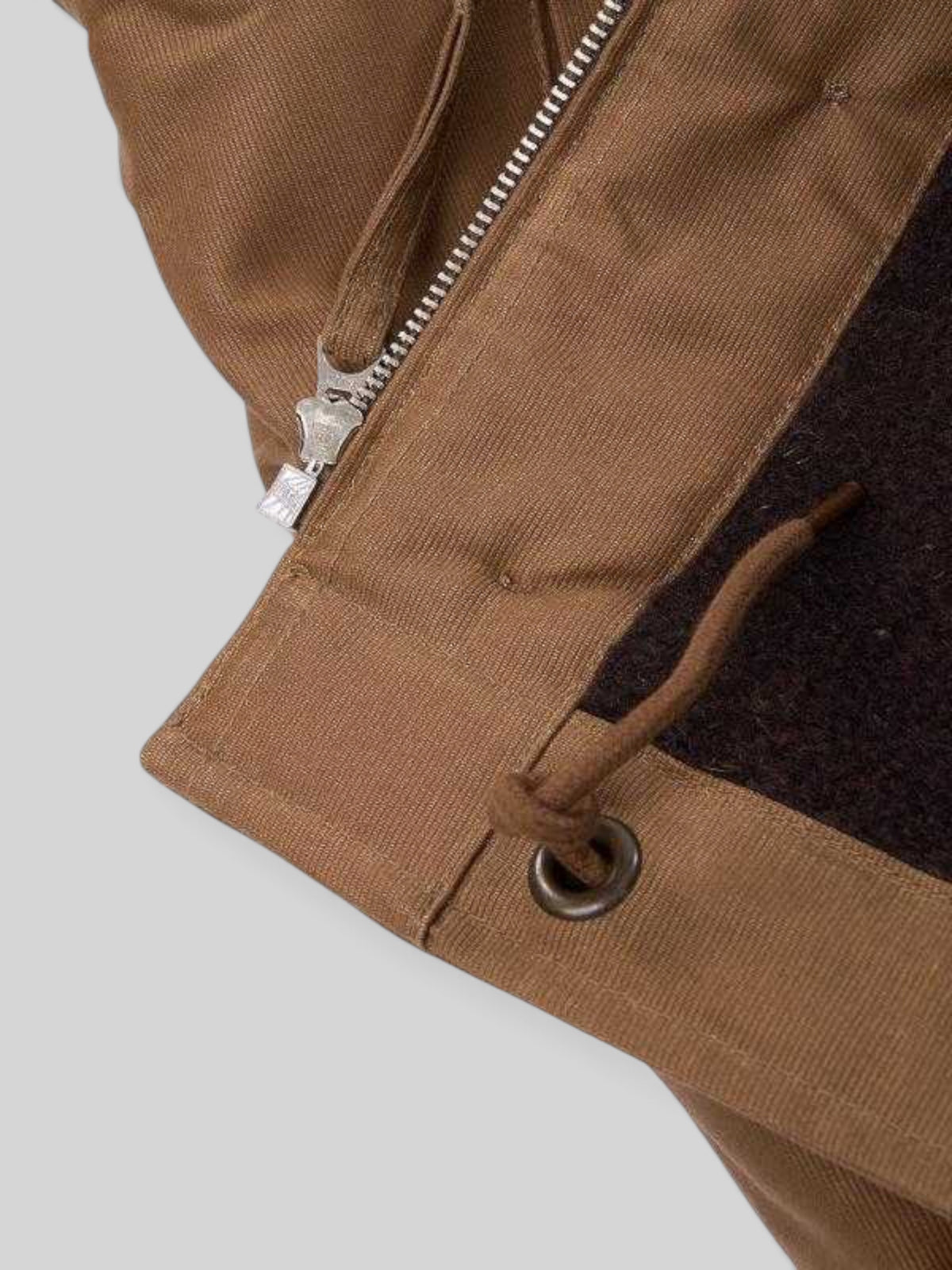 Baffle Haus 1944 N1 Deck Jacket in waxed khaki cotton with a dark wool lining and vintage Talon zipper detail