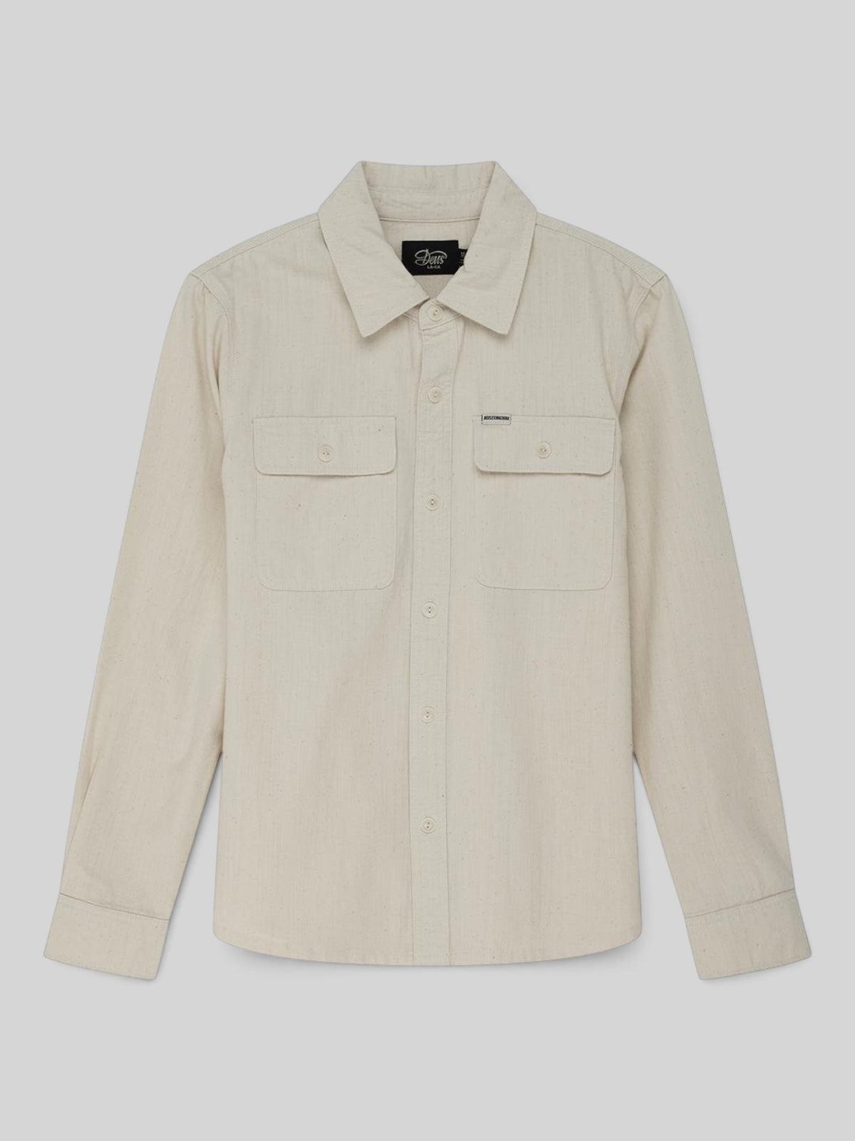 Baffle Haus Vacay Chambray Shirt in natural cotton with long sleeves, chest flap pockets, and corozo nut buttons.