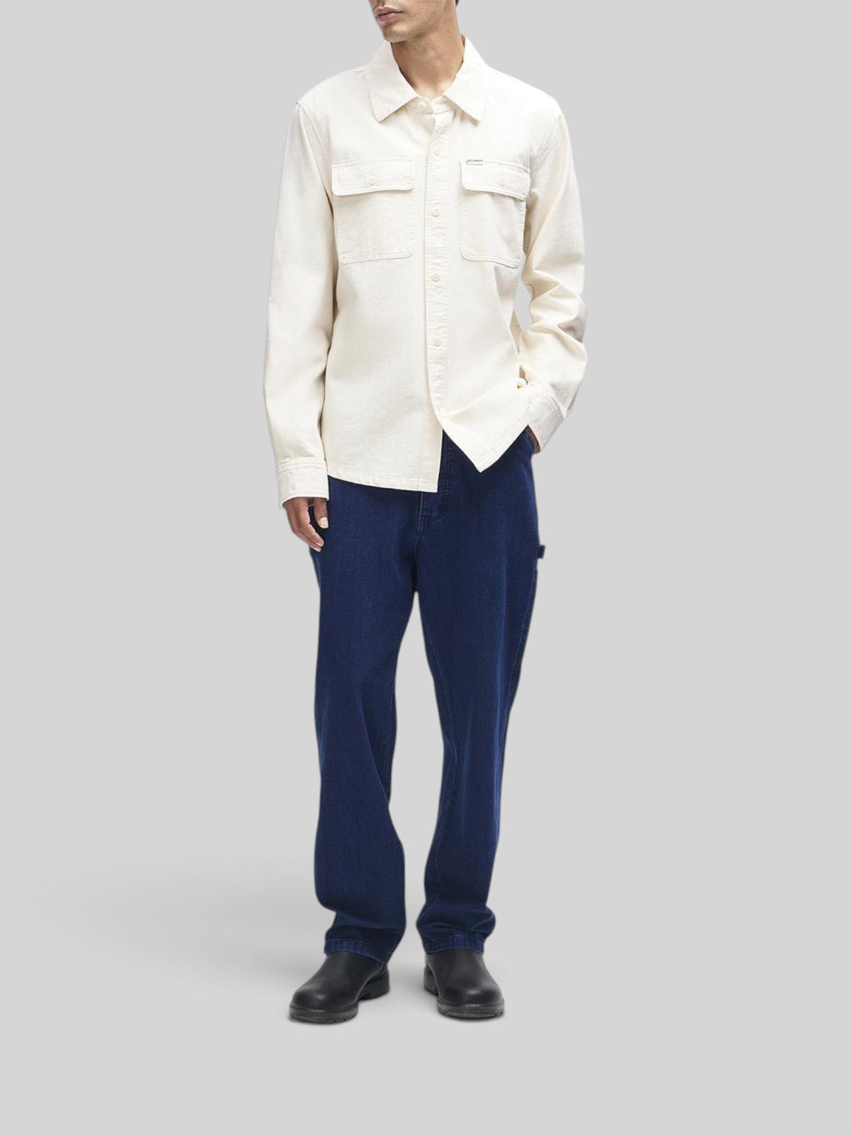 Baffle Haus Vacay Chambray Shirt in natural cotton with chest flap pockets and button closure on a male model