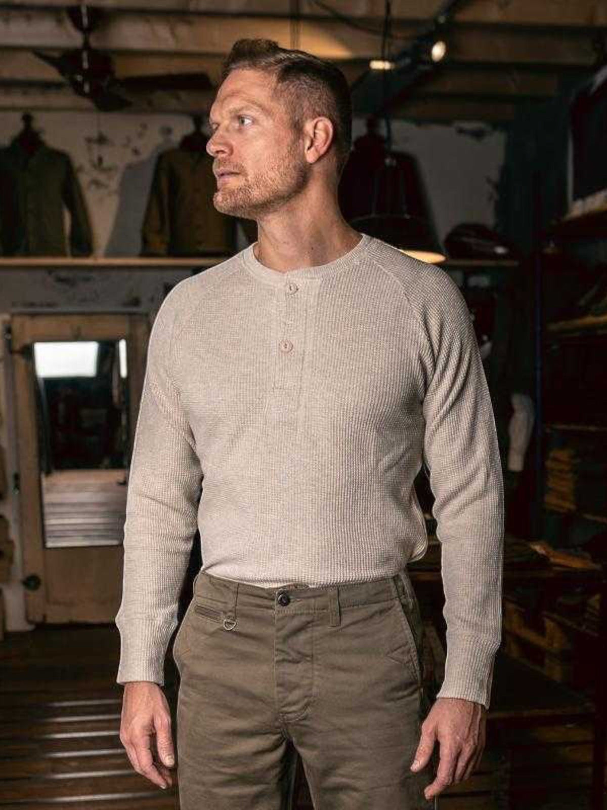 Baffle Haus 1936 natural waffle knit cotton shirt with button front detail worn by a man in a rustic workshop