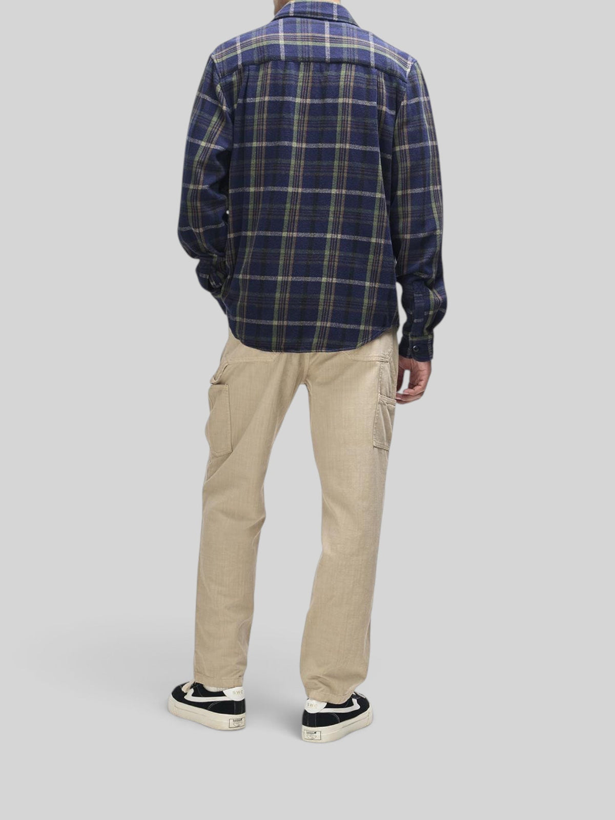 Baffle Haus Vacay Check Shirt in navy flannel worn with beige cargo trousers and black sneakers, back view