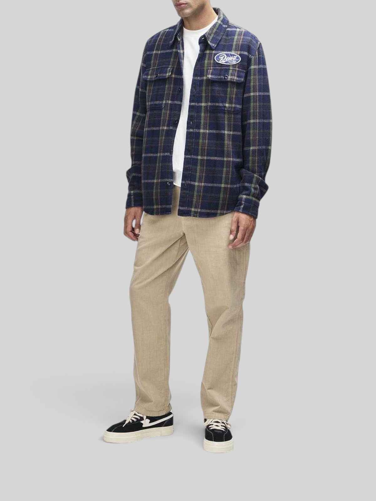 Baffle Haus Vacay Check Shirt in navy brushed cotton flannel with embroidered chest patch worn over a white tee