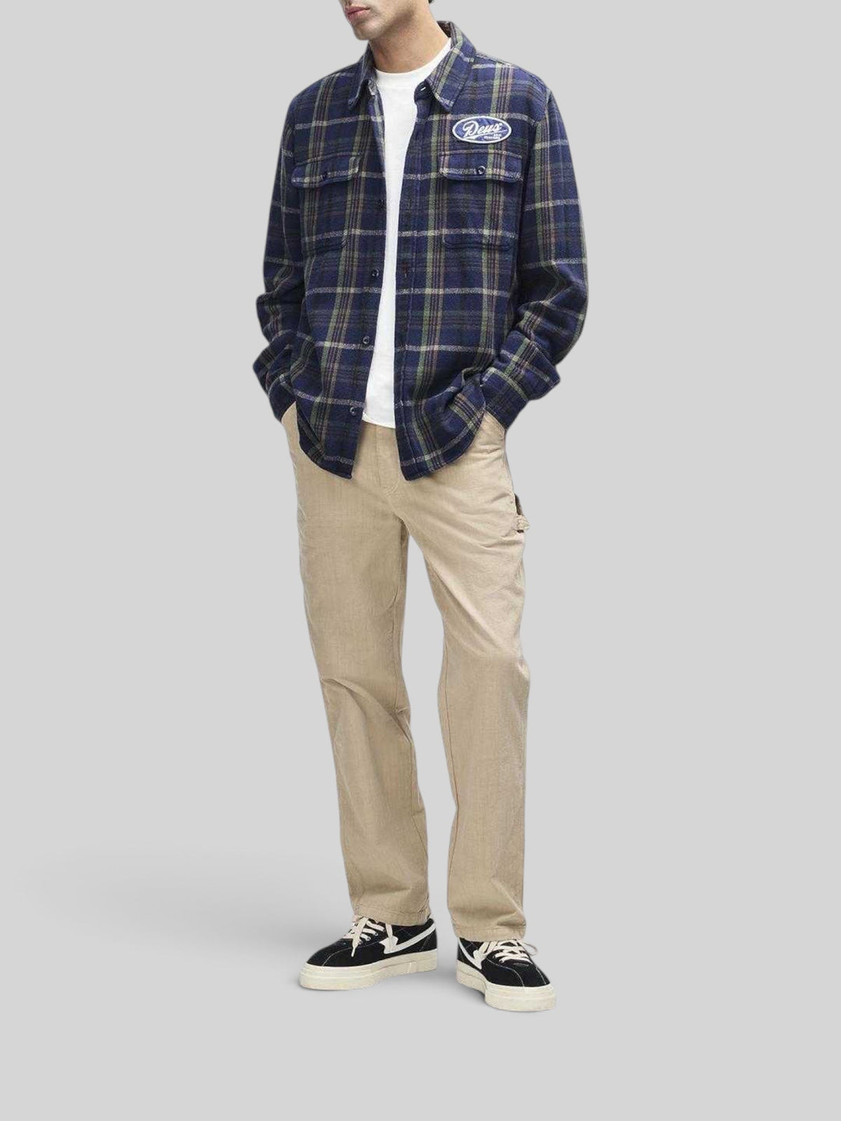 Baffle Haus Vacay navy check brushed cotton flannel shirt with embroidered chest patch worn over a white t-shirt