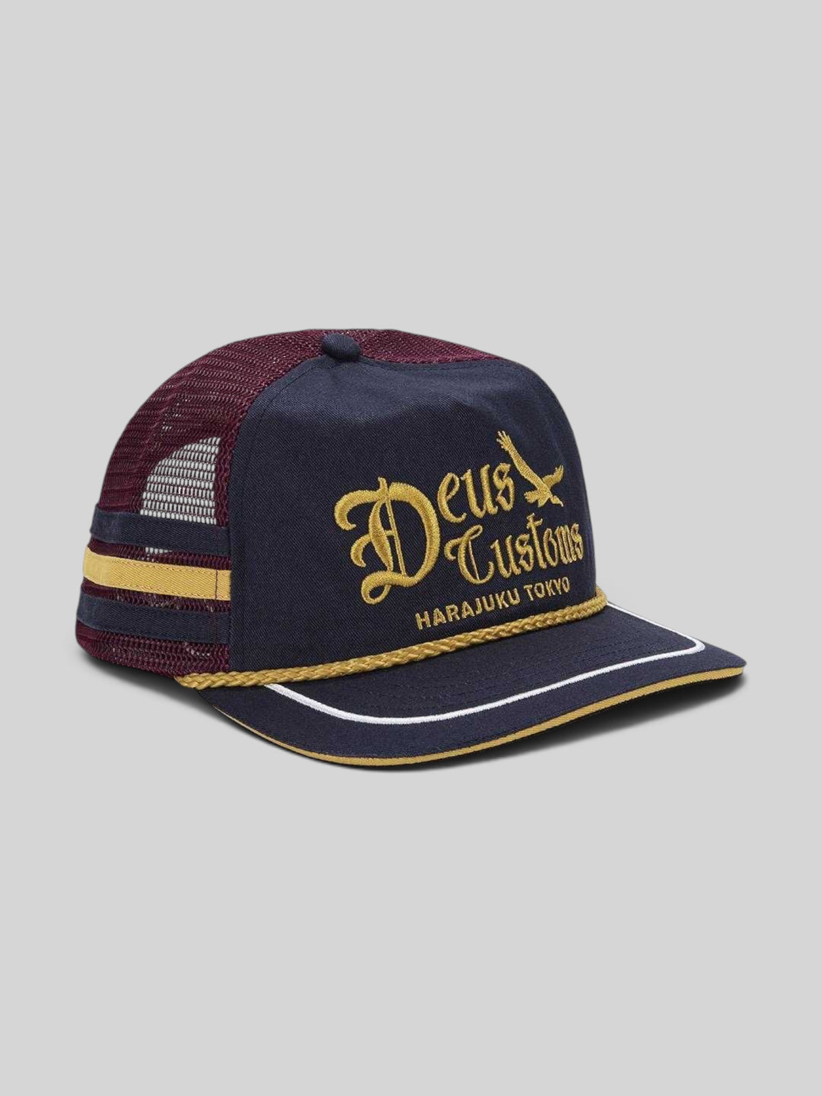 Baffle Haus Beep-Beep Trucker hat in dark navy cotton twill with gold embroidery, rope detail, and maroon mesh back.