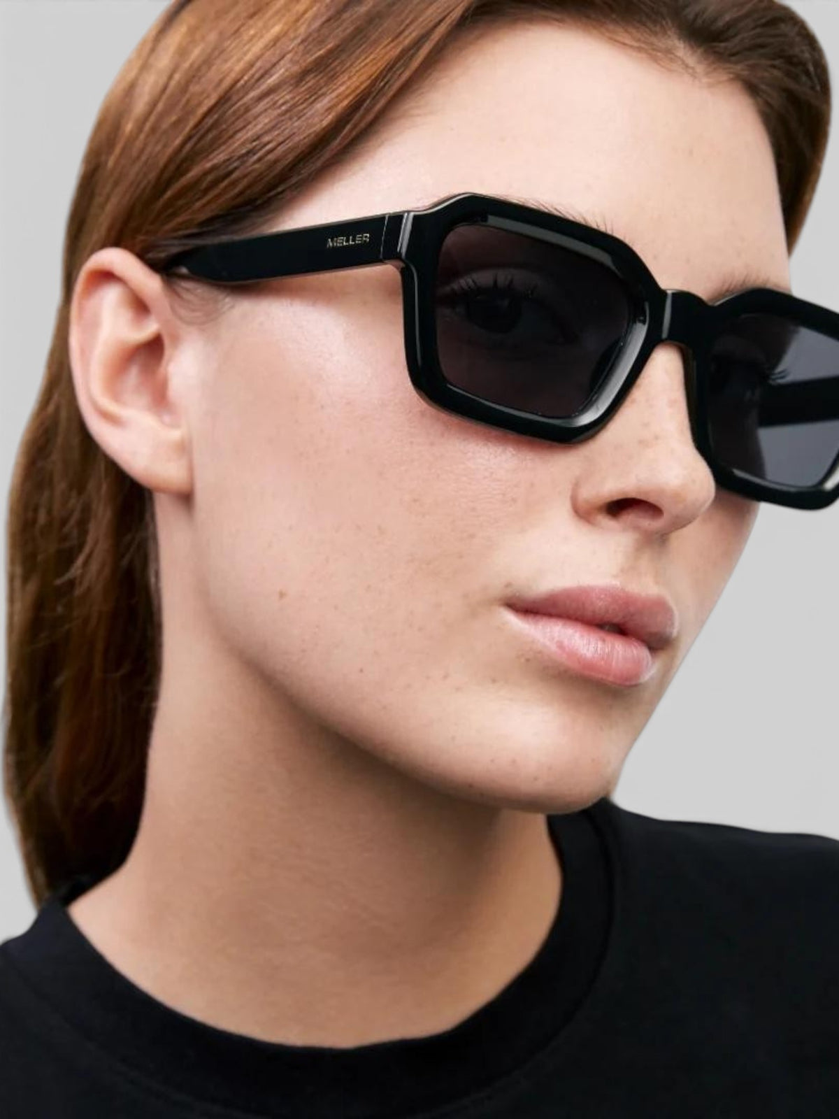 Baffle Haus NAYAH black bio acetate sunglasses with a squared 70s-inspired frame worn by a woman