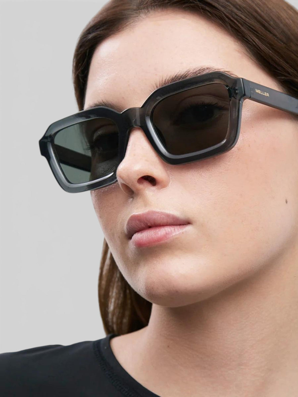 Baffle Haus NAYAH sunglasses in fossil olive bio acetate with a modern squared frame and polarized lenses on a model